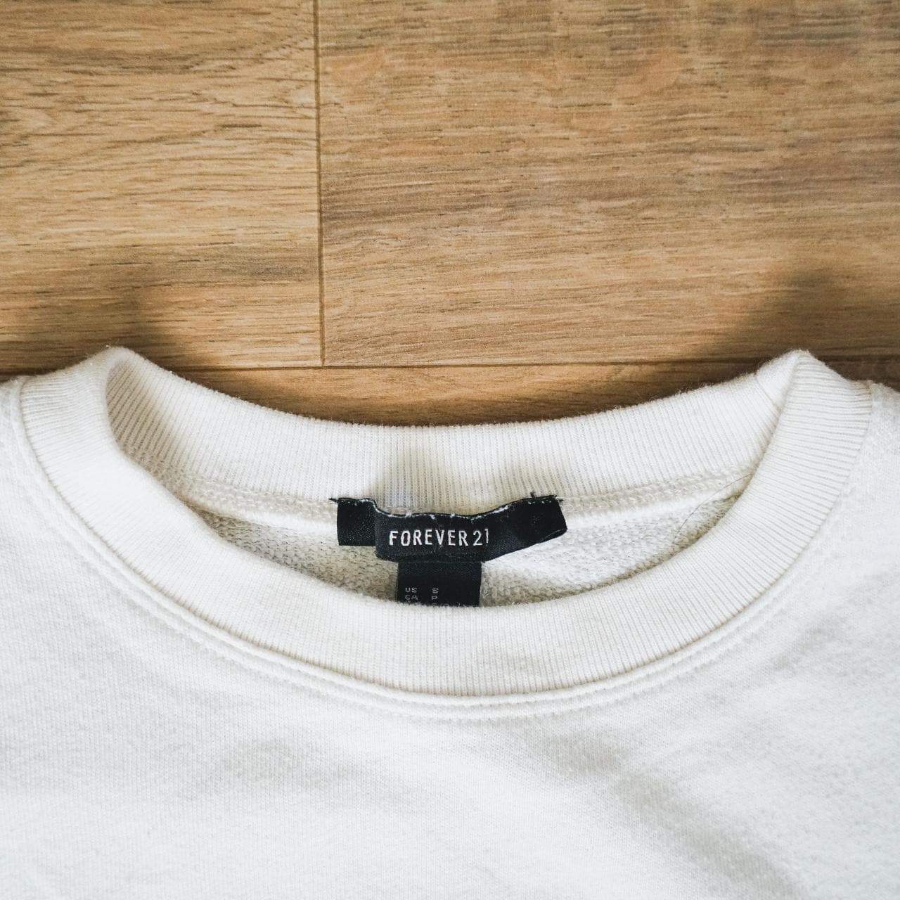 Cropped white pullover sweatshirt with rainbow accent stripe. A simple crop that can be dressed up or down. Women's size small 🌈 - Thumbnail 3
