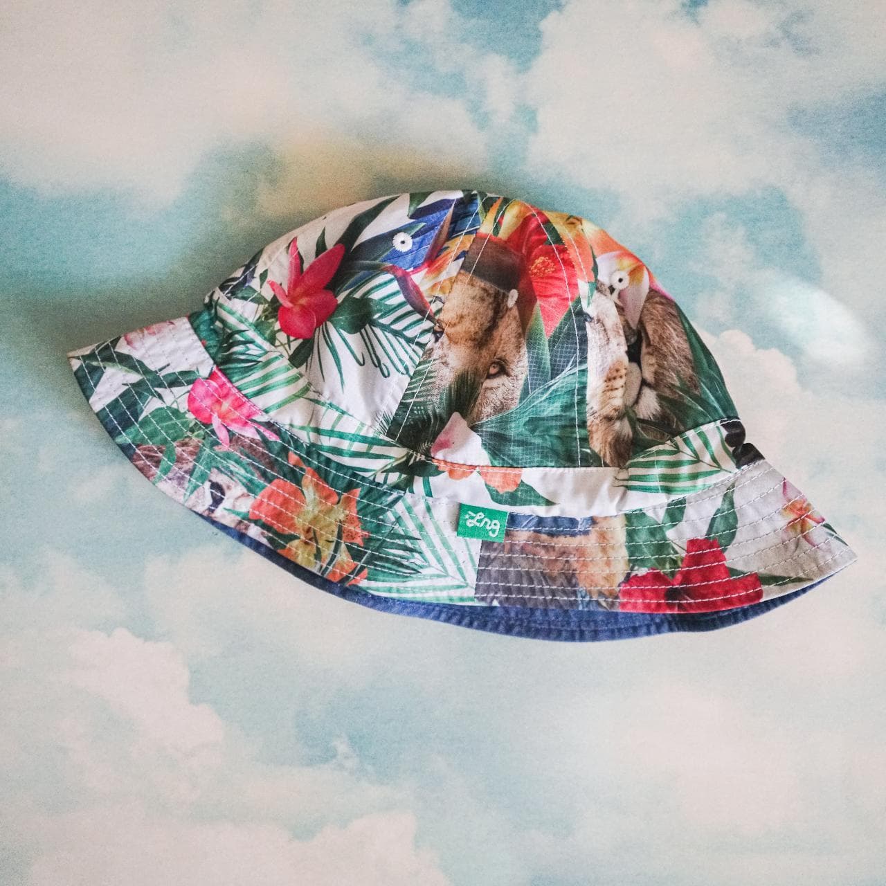 Crazy #LRG reversible bucket hat. Features medium-washed denim on one side with logo tag and full-color tropical print on the other side. The Y2K style is back and this accessory is perfect for the Summer 🌲