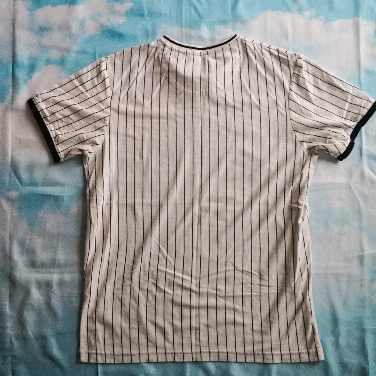 White and black pin striped shirt with a small "Instinct" logo on the front. Features contrast sleeve cuffs. Size adult small 👟 - Thumbnail 3