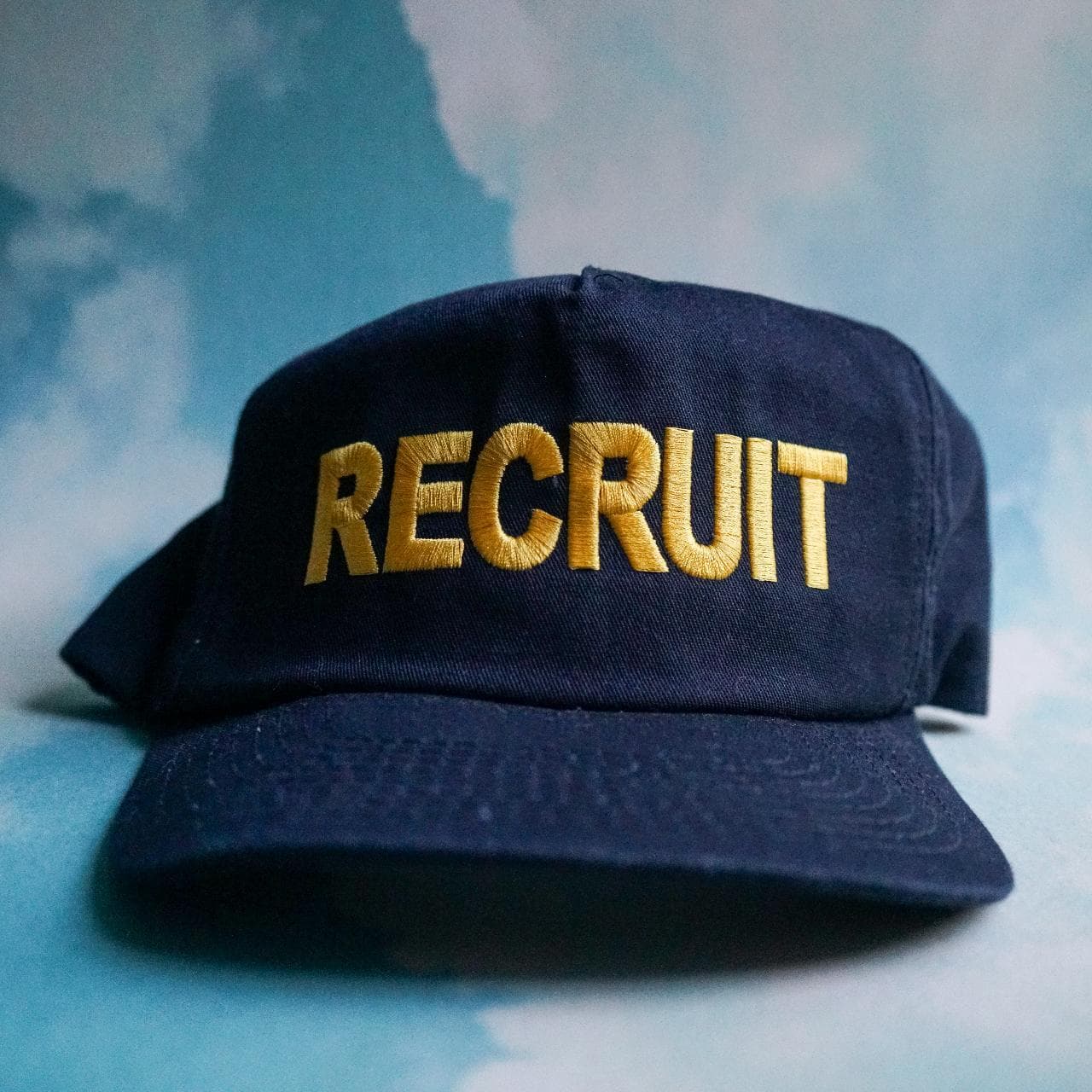 Police "Recruit" hat in black and yellow. Features a structured A-frame dome and adjustable snap closure. One size fits all 🧢