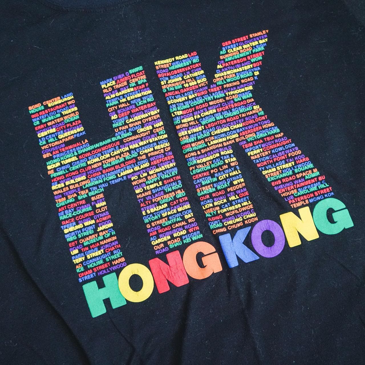 HONG KONG logo tee in black with multicolored print. Features raised puff print. Asian adult size large, fits more like a medium 🔋 - Thumbnail 2