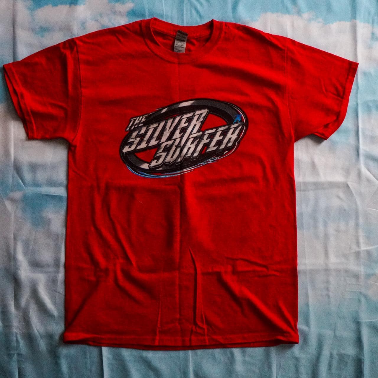 Silver Surfer street racing tee in red with black, blue, and silver accents. Features full-color graphics on the front and back 🏎 Adult size large.