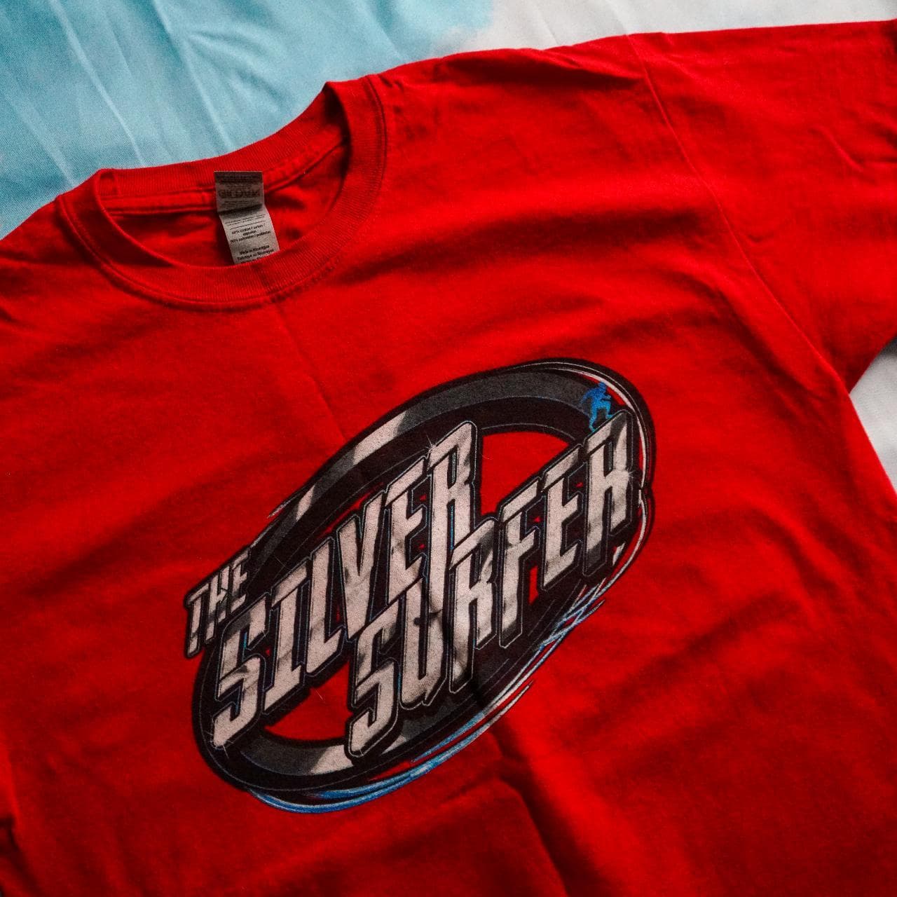Silver Surfer street racing tee in red with black, blue, and silver accents. Features full-color graphics on the front and back 🏎 Adult size large. - Thumbnail 2