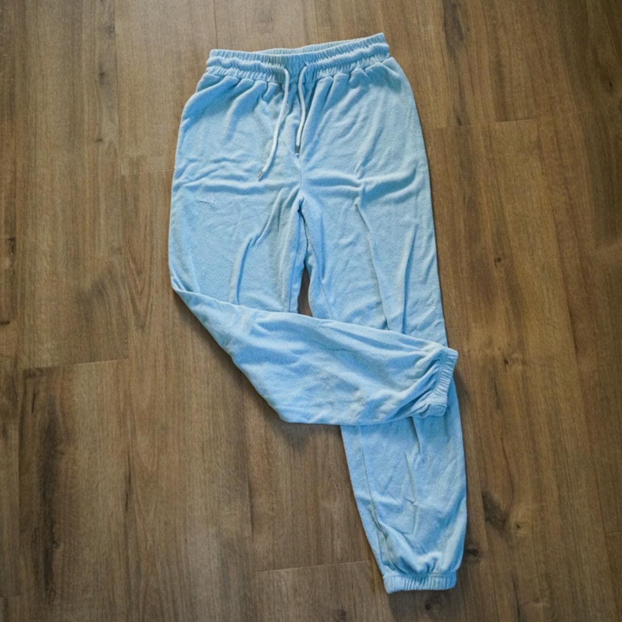 Light blue #terrycloth sweatpants with adjustable metal tipped drawstring. Jogger style ankle with pockets on the front.