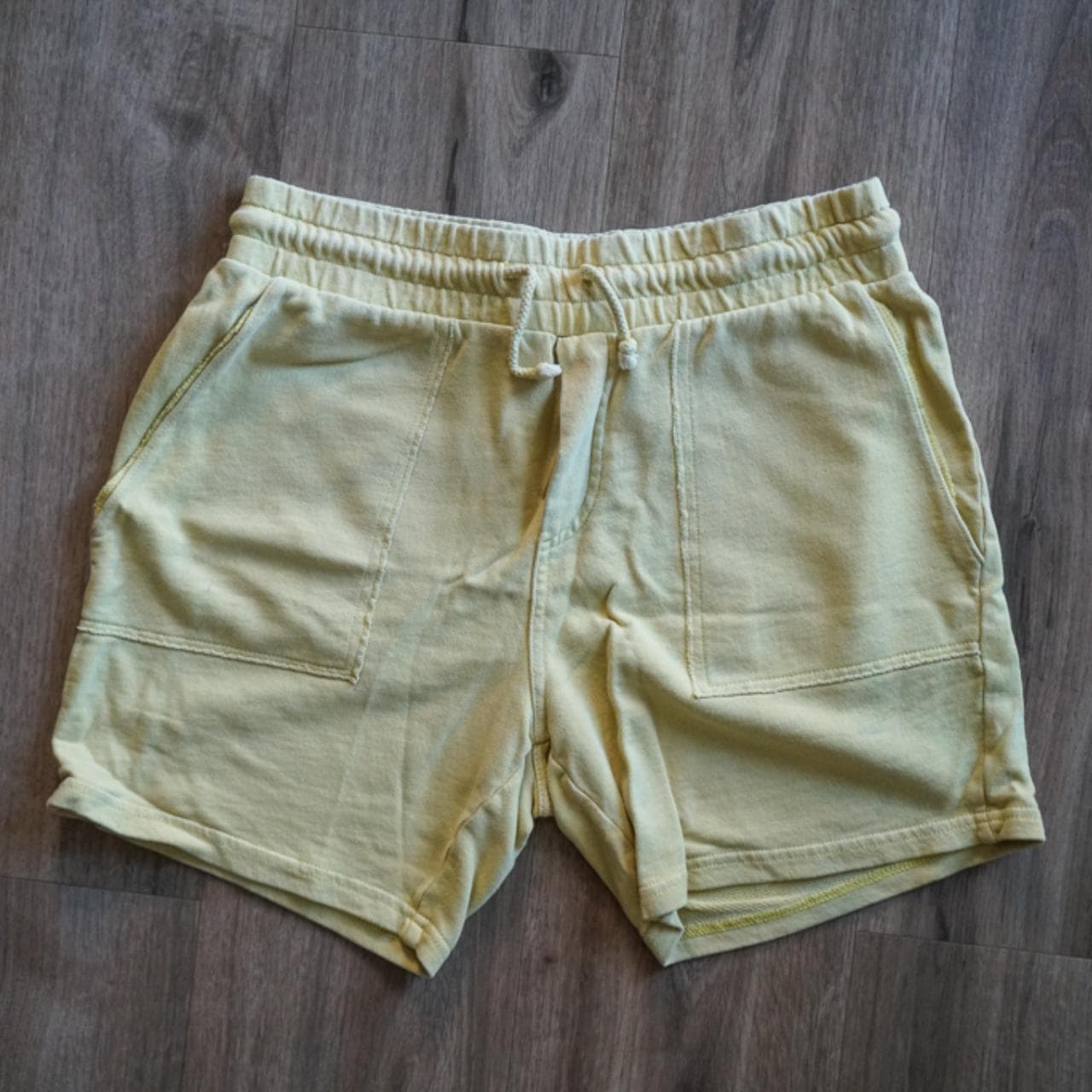 Yellow sweat shorts in size adult small. Elastic waistband with drawstring and pockets on both the front and back. - Thumbnail 2