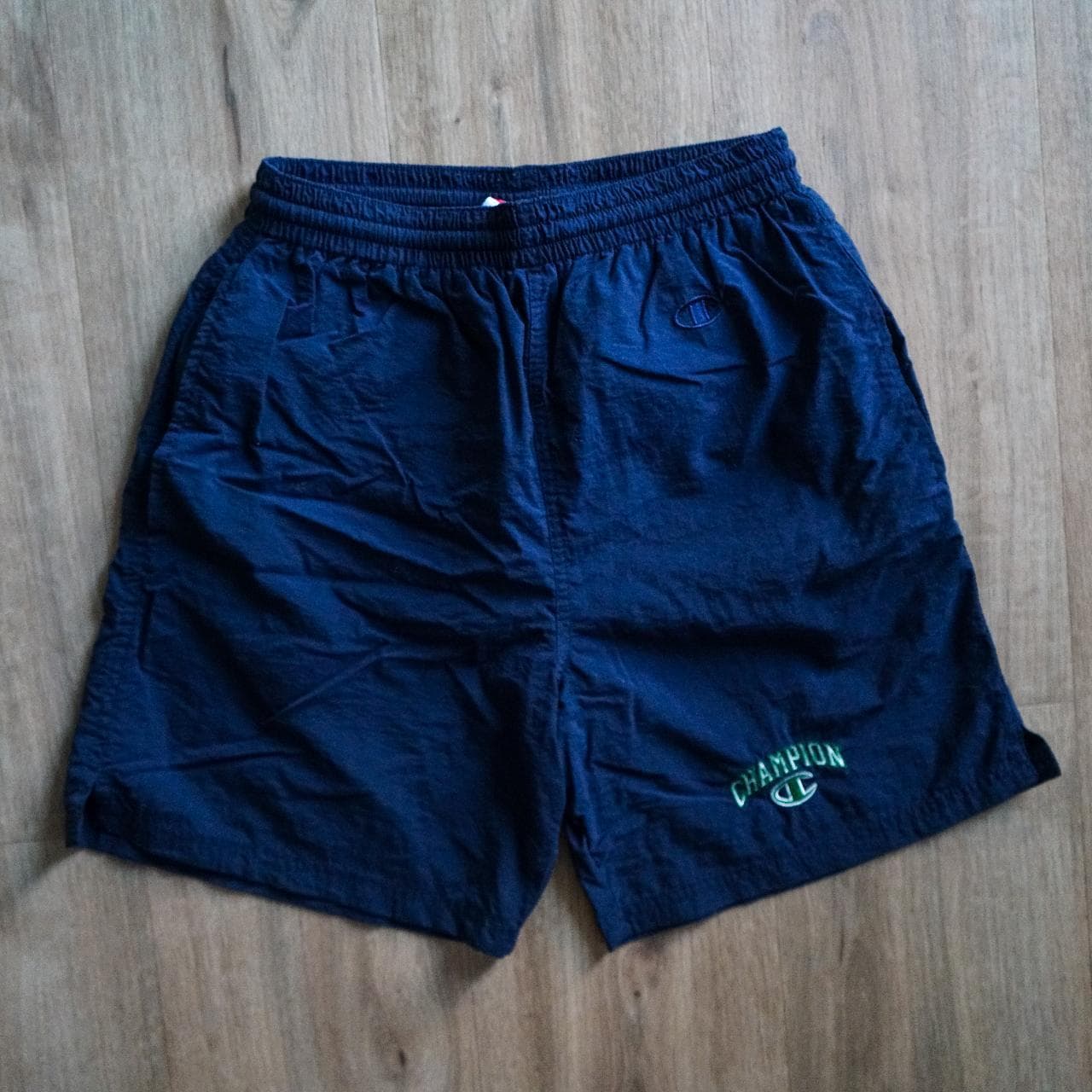 Navy #Champion shorts/swim trunks with sewn-on logo in kelly green and white 🍀 Shorts feature an inner liner, drawstring, and front pockets. Size adult small.