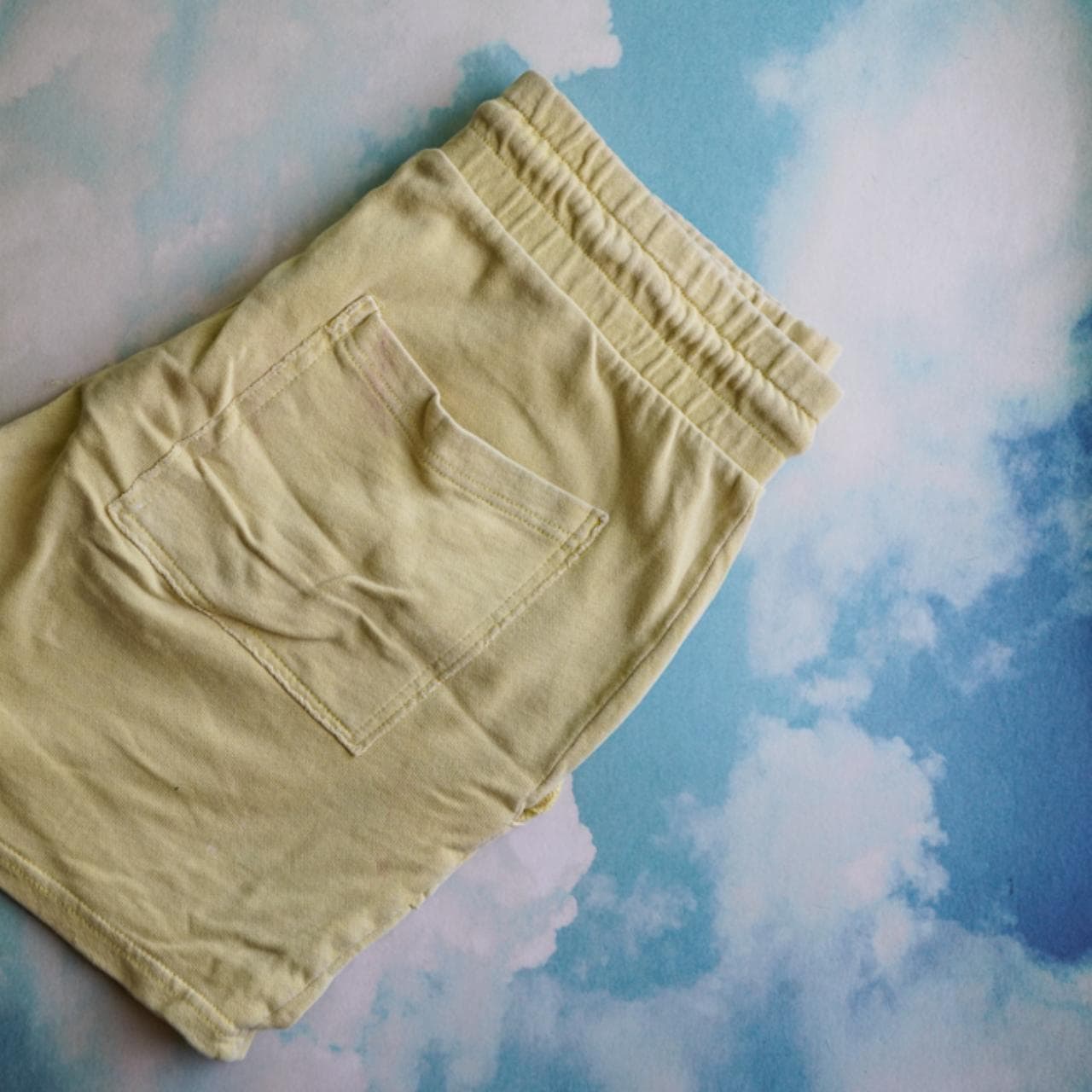 Yellow sweat shorts in size adult small. Elastic waistband with drawstring and pockets on both the front and back.