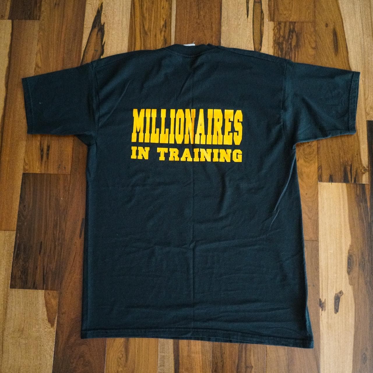 S.W.A.T. Millionaires in Training vintage tee in black with yellow text graphics on the front and back 💰 Small bleach discoloration on front.