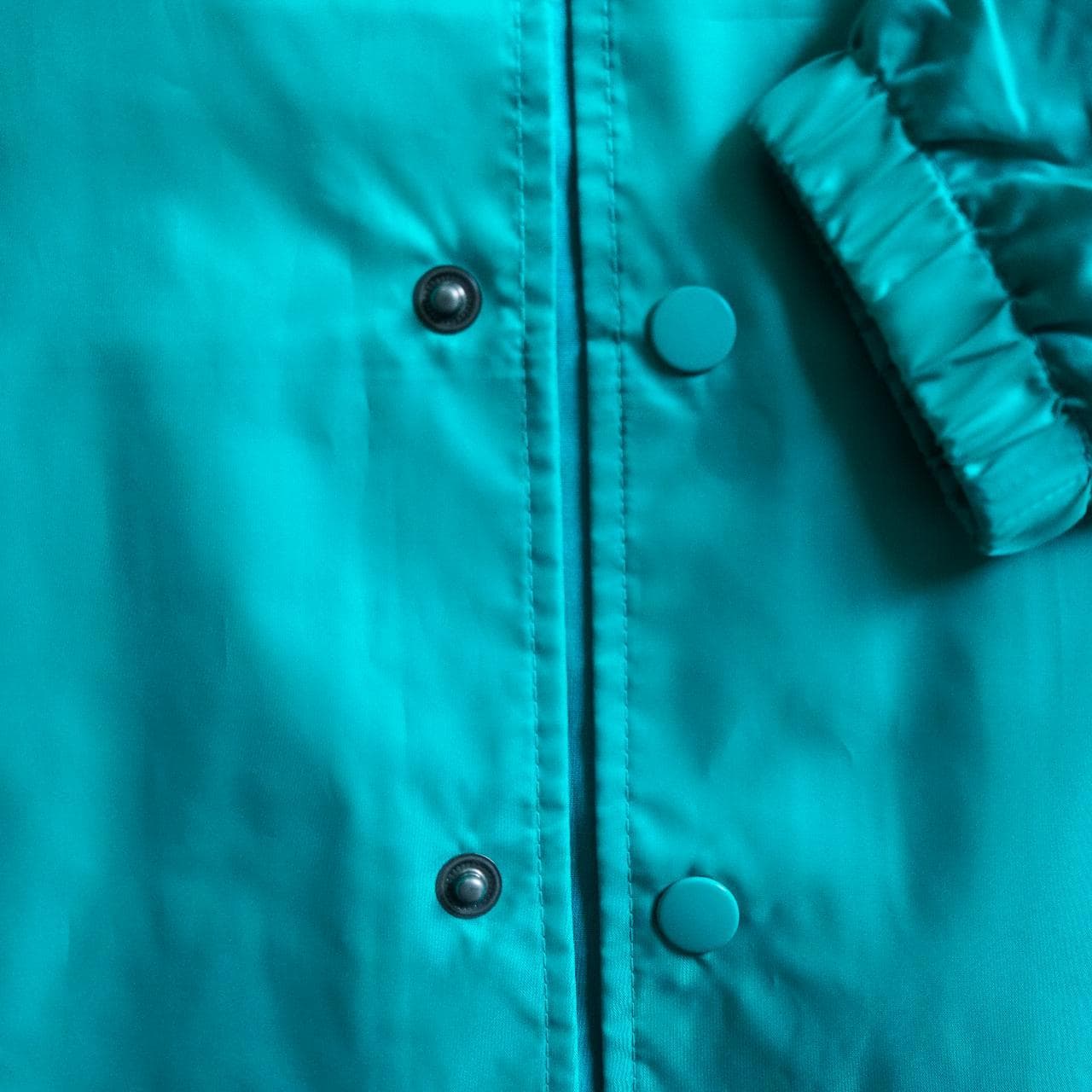 Turquoise #Champion coach's jacket with logo accent 🦋 Features snap button closure, drawstring, and elastic sleeves. Size adult small. - Thumbnail 3