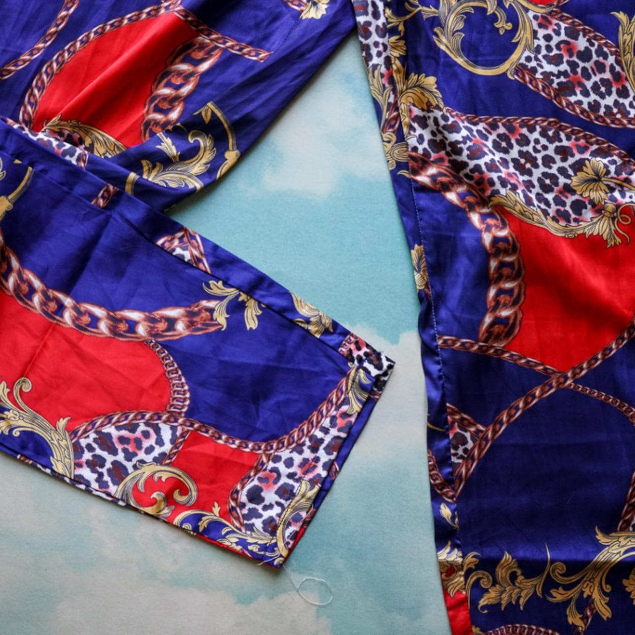 Patterned dress pants with side zipper closure. Blue, red, and animal print with chain accents. Tailored leg closure. Size women's small. - Thumbnail 3