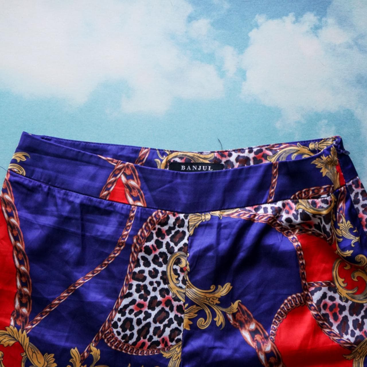 Patterned dress pants with side zipper closure. Blue, red, and animal print with chain accents. Tailored leg closure. Size women's small. - Thumbnail 2