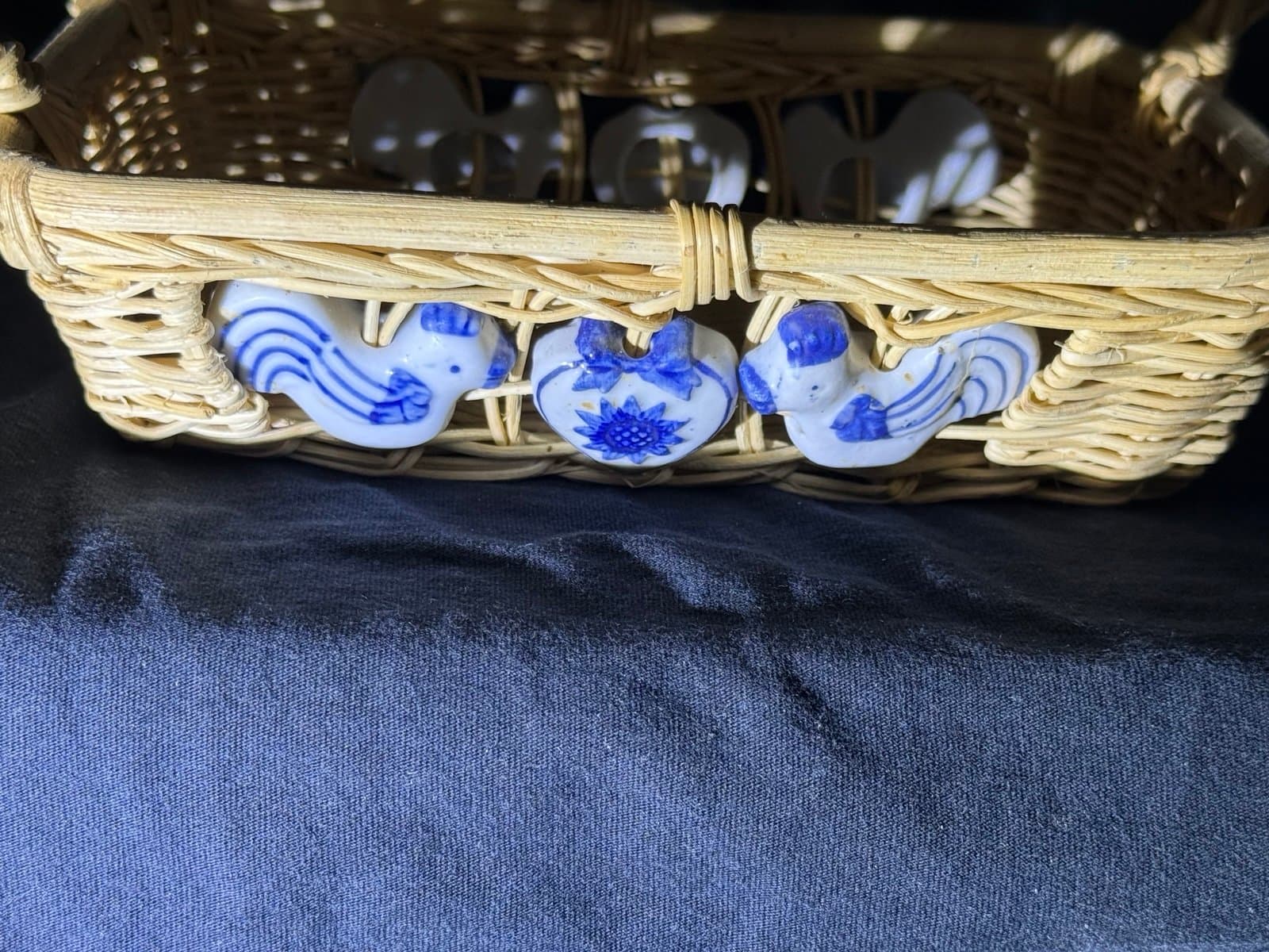 vintage wicker basket with ceramic bird and heart decorations