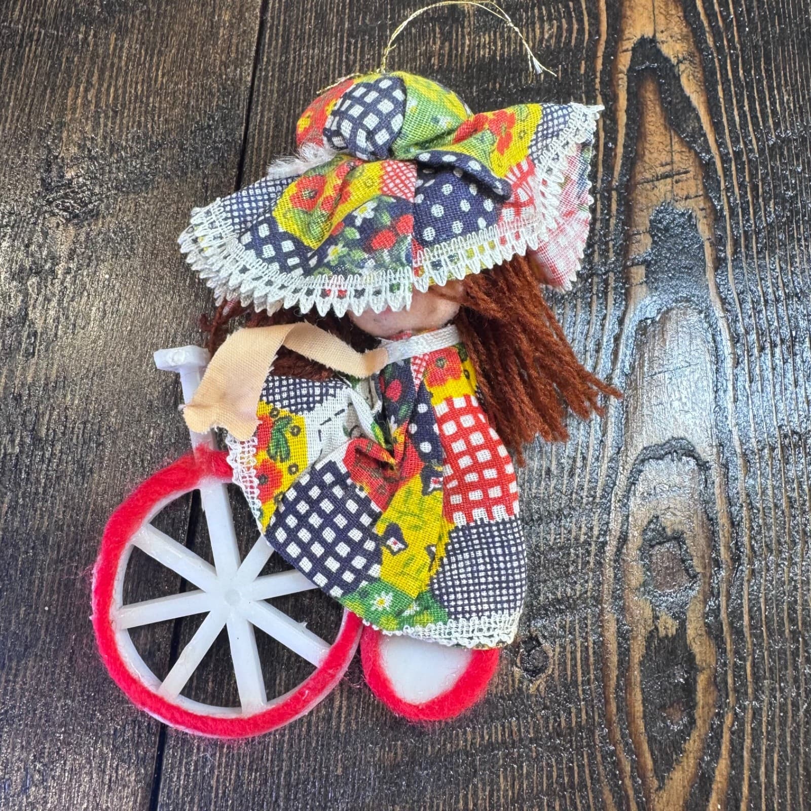 Vintage Christmas holiday tree ornament doll girl with hat on bike bicycle