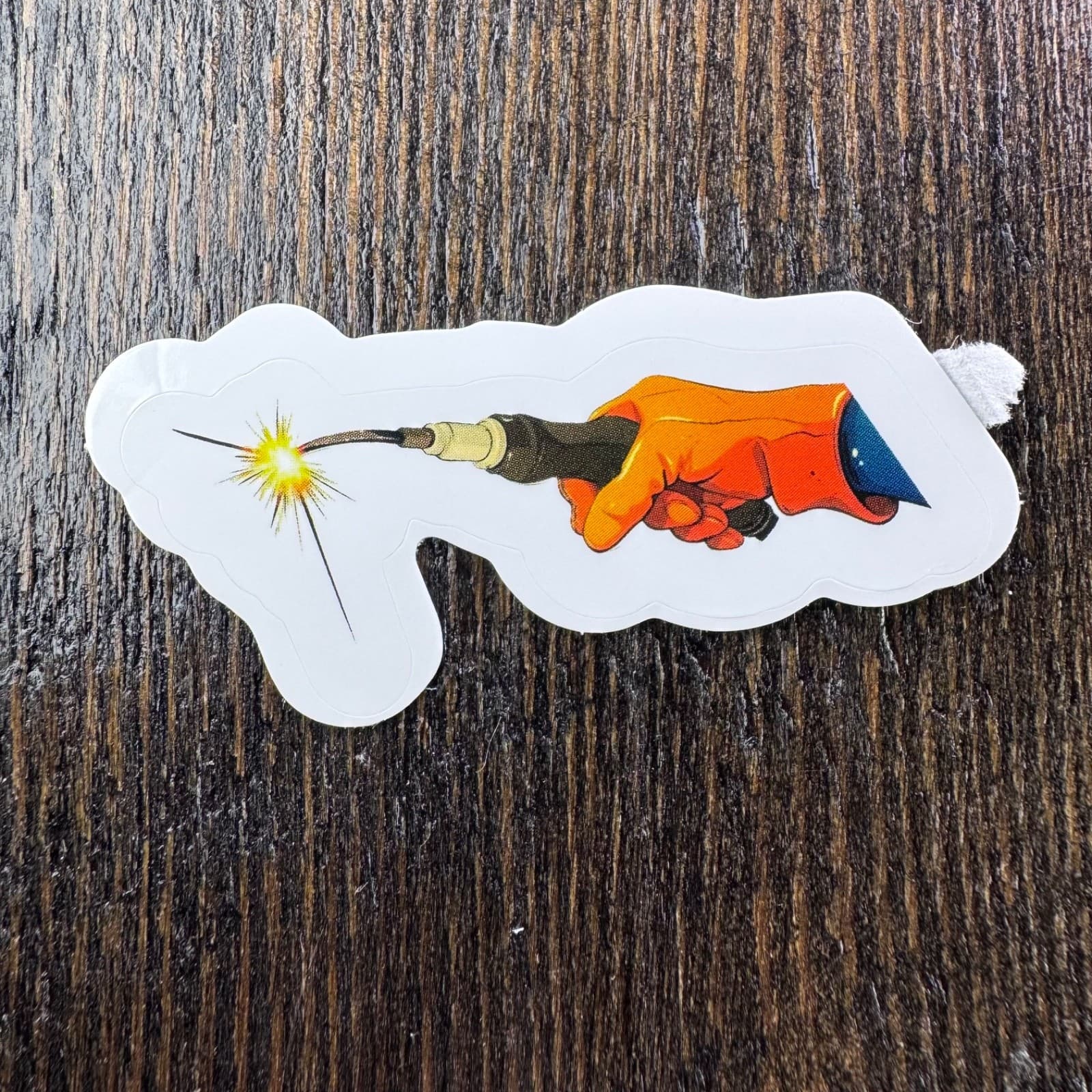 Hand holding Torch Sticker Welder- Water Bottle Phone Laptop Skateboard Hard Hat