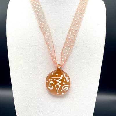 Amber & white swirled round glass pendant necklace on sheer polka dot ribbon