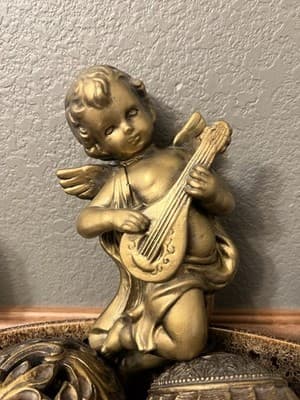 This Decorative Cherub Figurine Represents A Popular Mid-20th Century Home Decor