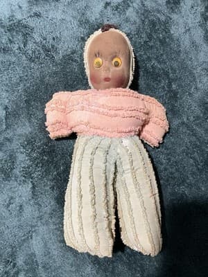 A Handmade Fabric Doll with Googly Eyes and Vintage Clothing. Antique. Handmade