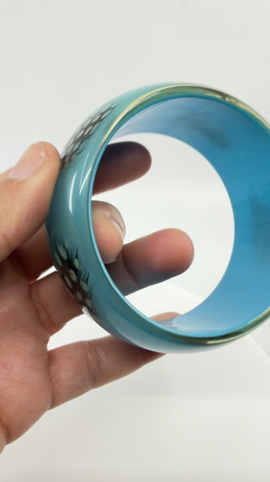 Vibrant Teal Resin Bangle Bracelet with Spotted Feather Accents Boho Statement - Video 8