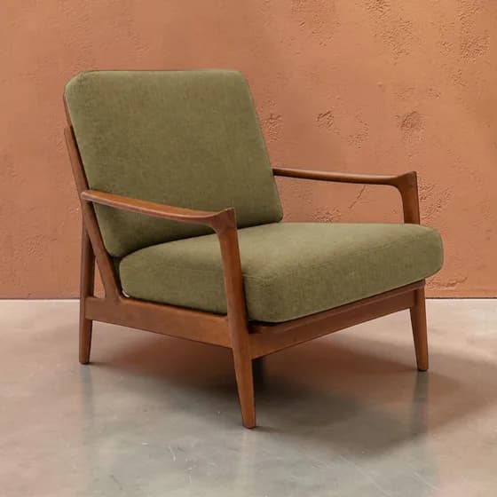 The same chair staged against a terracotta wall
