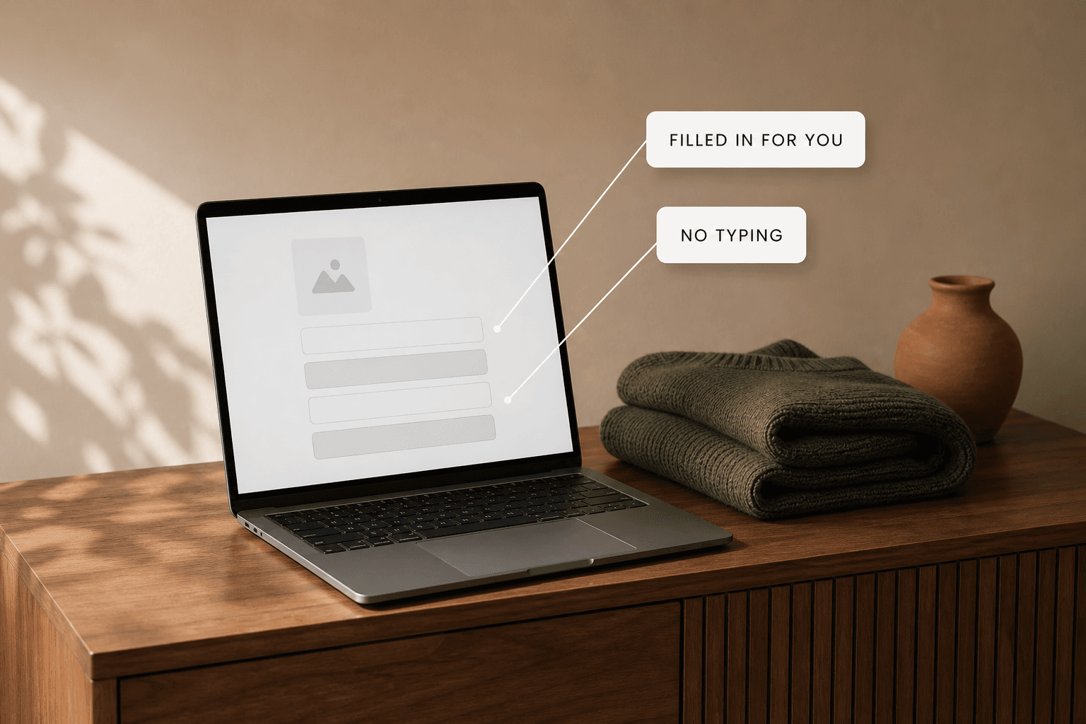 A laptop closed on a warm desk beside a stack of packed parcels, labelled hands off