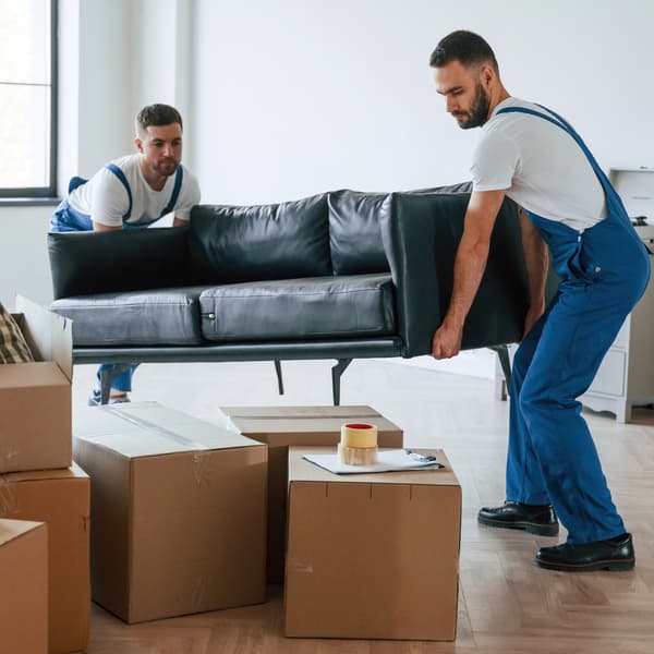 Same-day local delivery team moving a sofa
