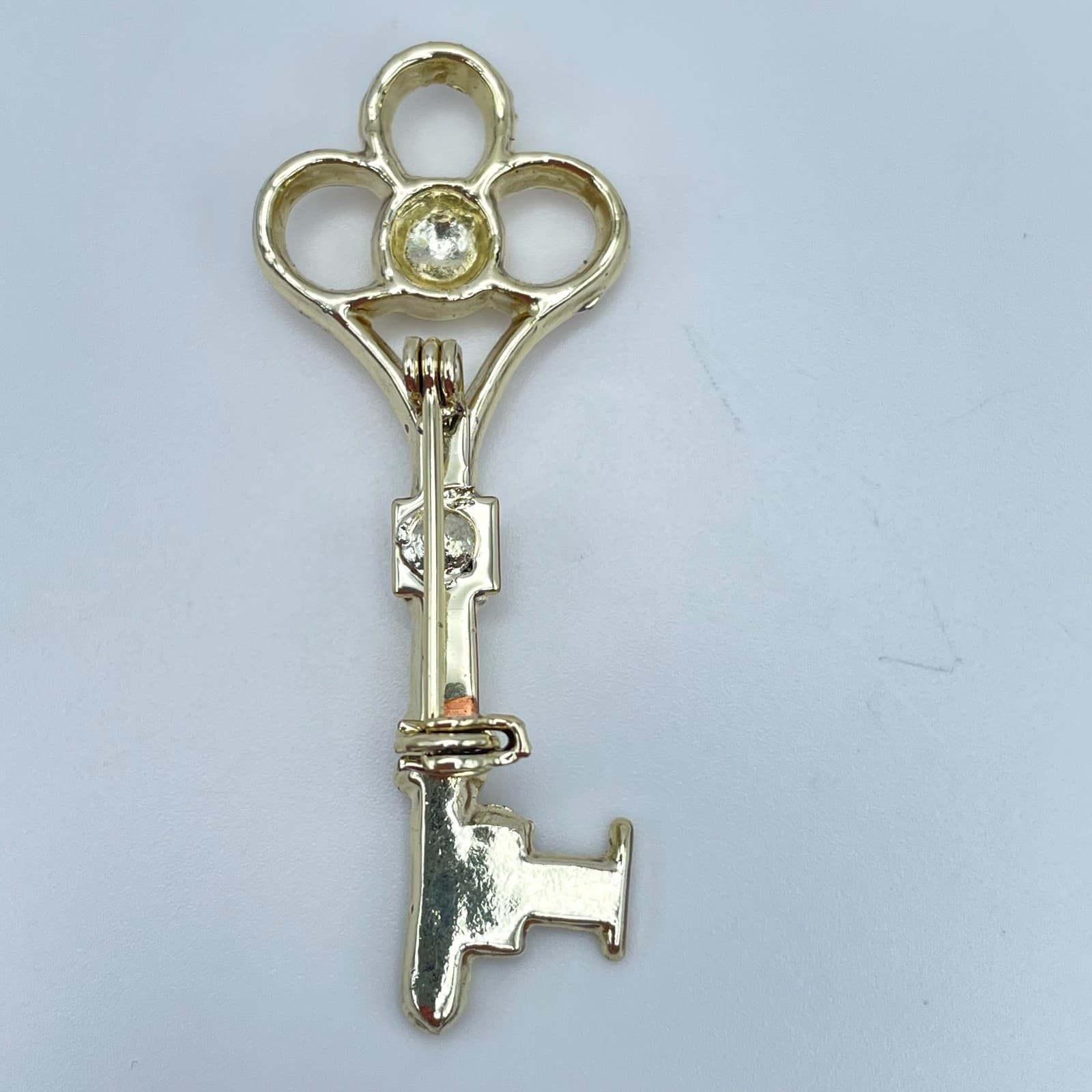 Vintage Gold-Tone Engraved Metal Embellished Skeleton Key Roll-Over Brooch Pin - Image 1