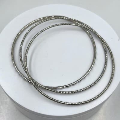 Vintage Set of 3 Silver Tone Textured Bangle Bracelets Hammered & Diamond Cut - Image 1