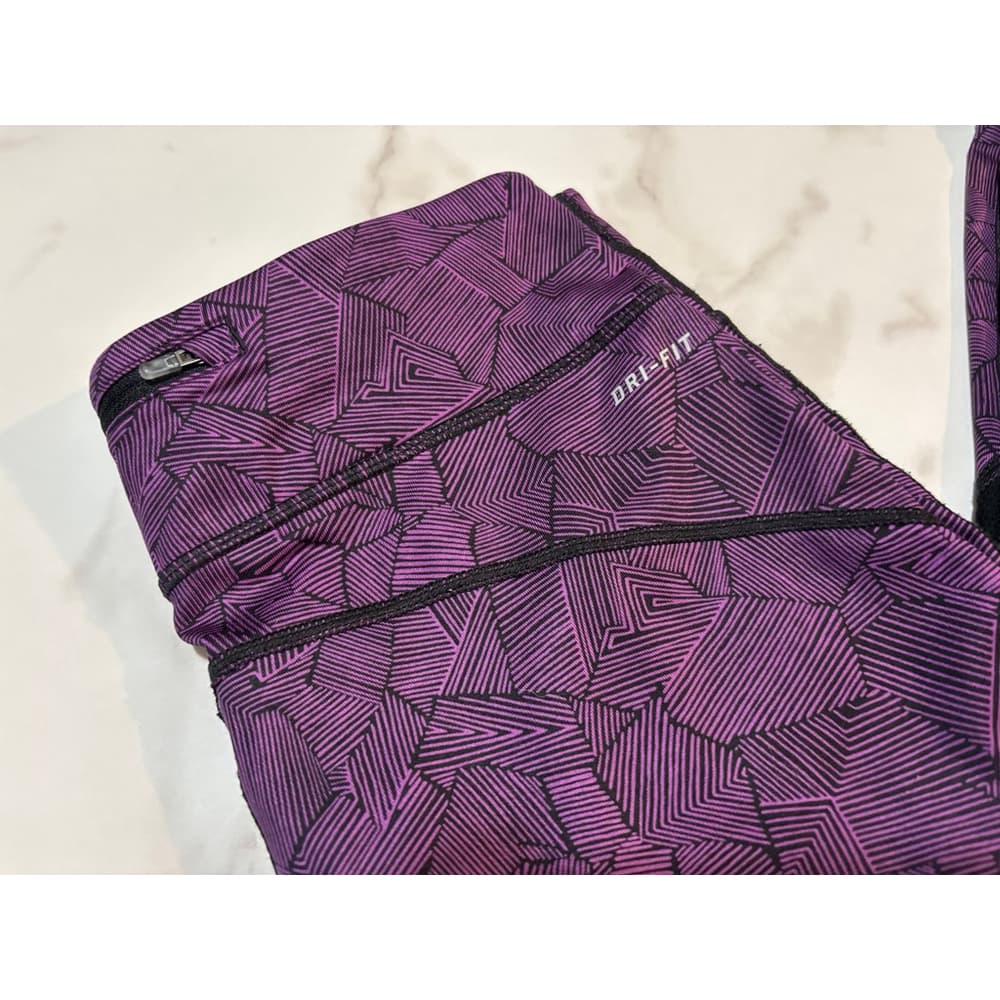 Nike Dri-FIT running leggings in a purple and black