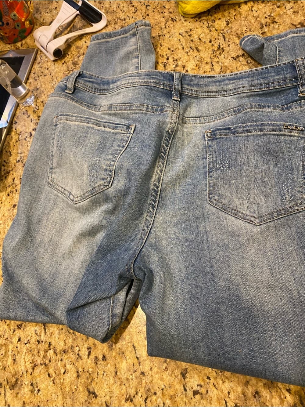 Bebe Light Wash Distressed Jeans with 'Peace + Love' Embroidery