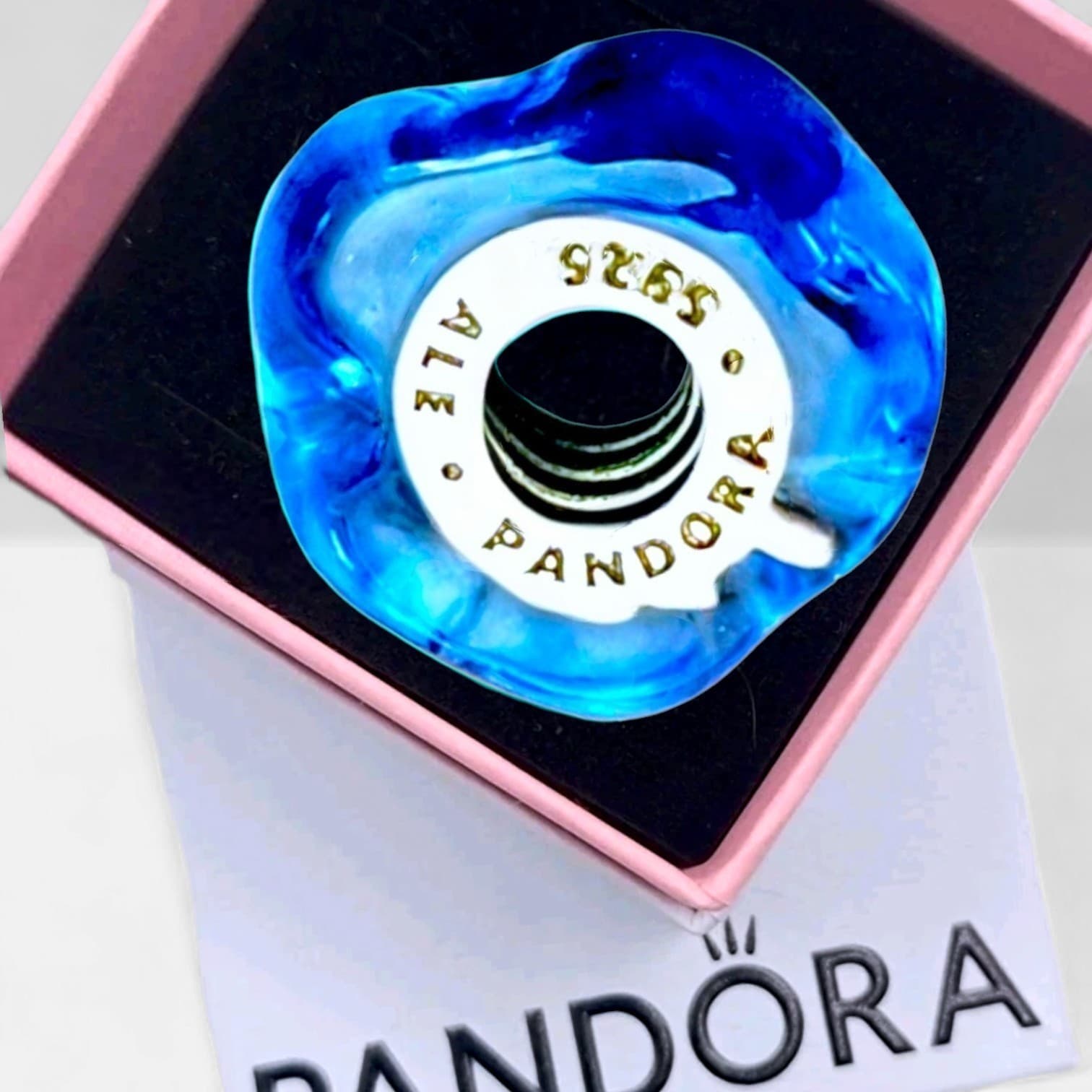 Pandora charm is a very rare find, featuring a wavy blue Murano glass