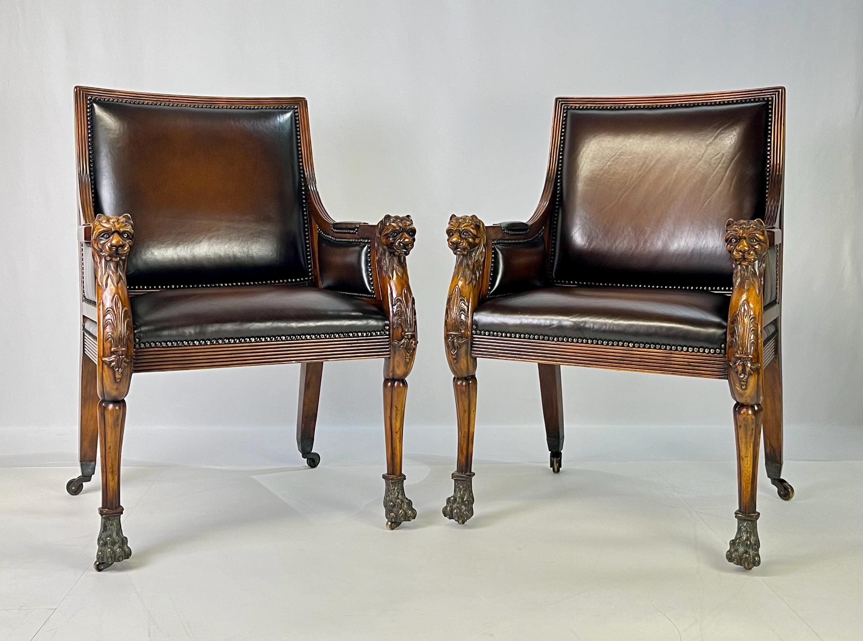Pair of Theodore Alexander Regency Style Carved Lion & Hairy Paw Caster Armchairs in Brown Leather