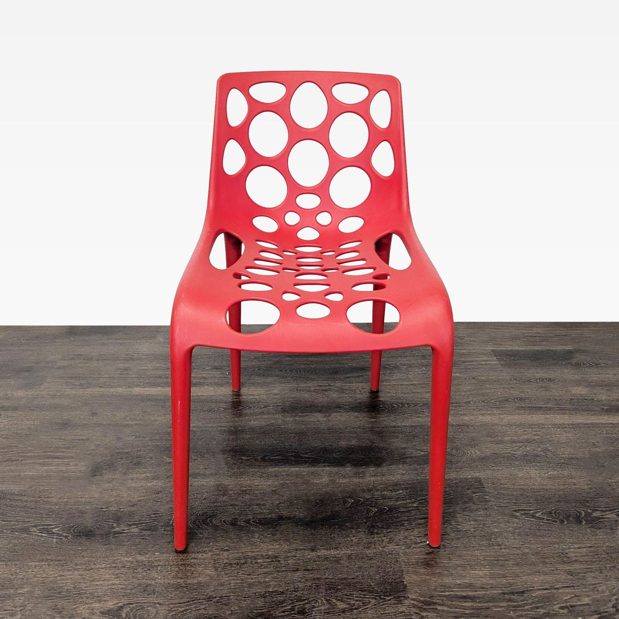 Red Plastic Dining Chair with Circle Cut-Outs