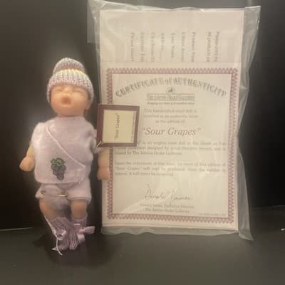 SOUR GRAPES 4 INCHE BABY DOLL FROM ASHTON DRAKE GALLERIES MINT IN SHIPPER