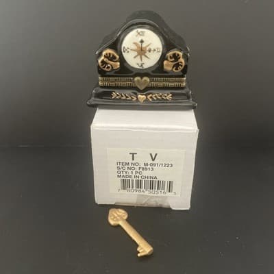 Porcelain black and gold mantle clock trinket box with gold key trinket
