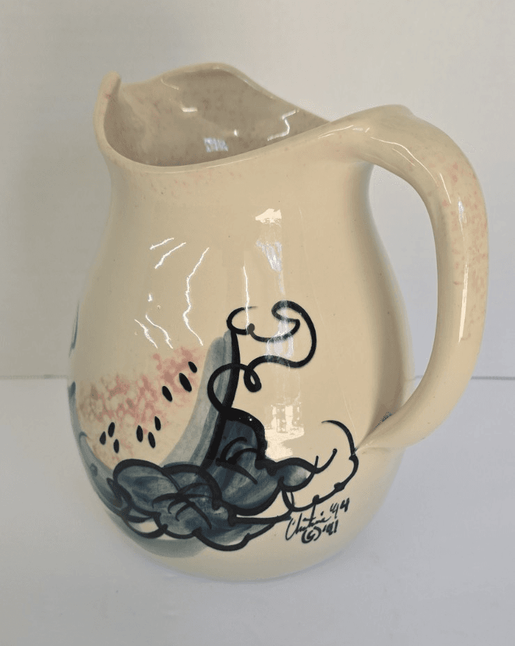 Vintage Ellis Pottery pitcher features a cream-colored glaze and hand-painted