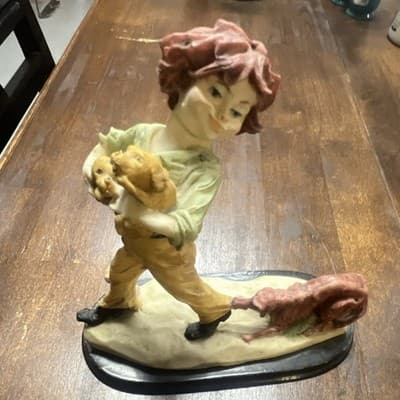 vintage porcelain figurine titled "Boy with Labrador Retriever and Puppies”