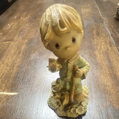 vintage ceramic figurine titled "Boy Holding Flower" hand painted sculpture