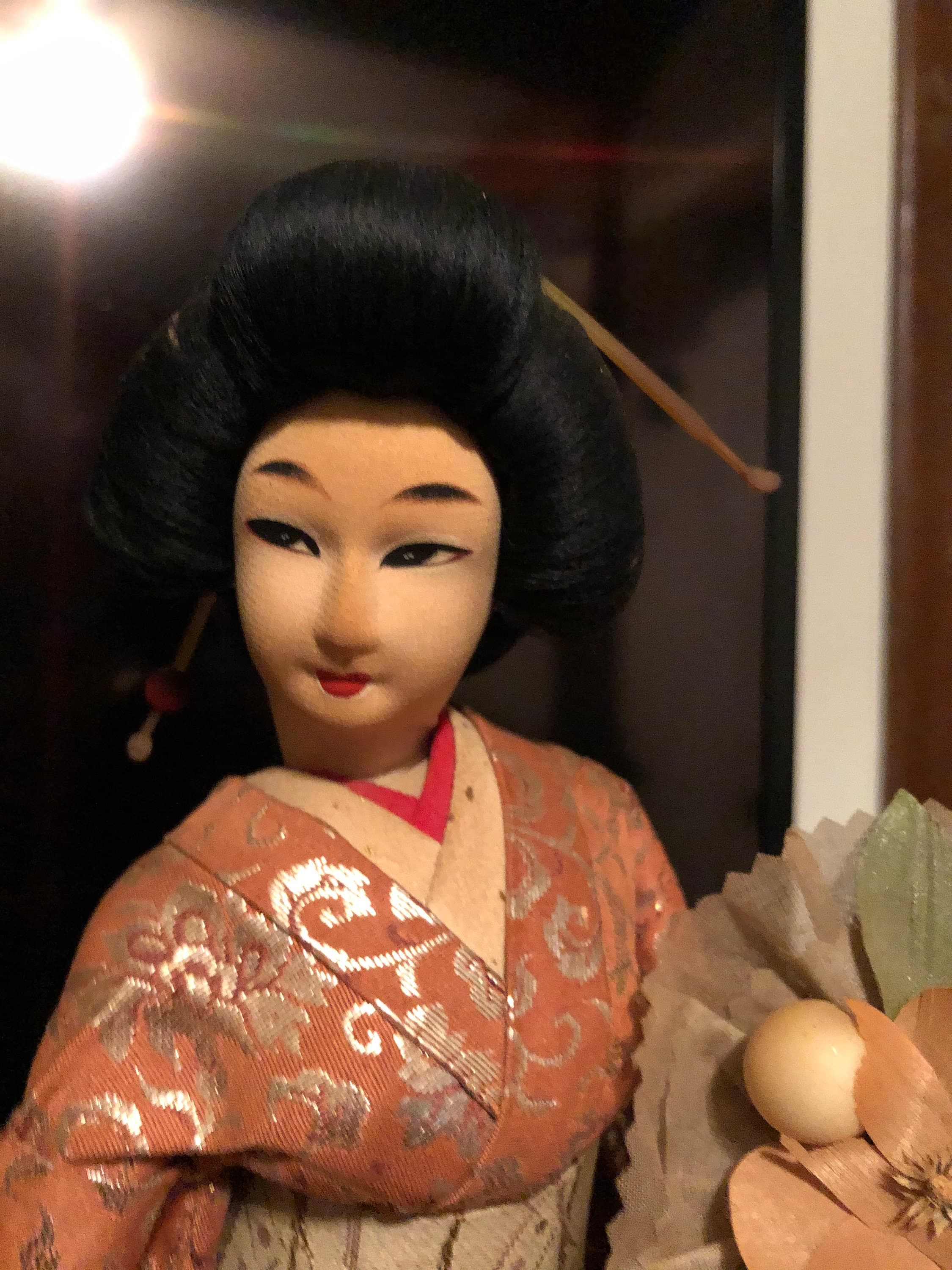 Geisha Performer with a flower bouquet on platform