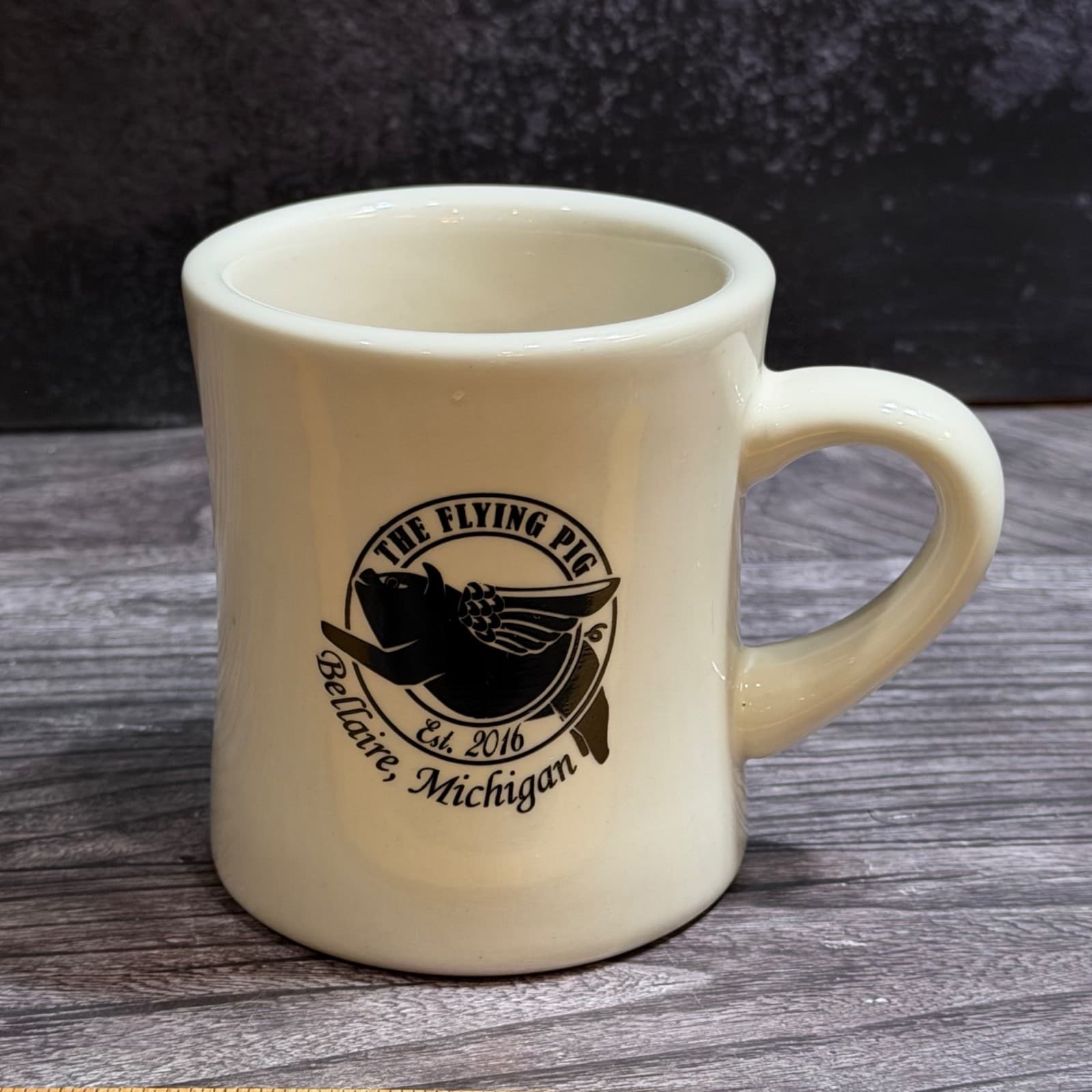 The Flying Pig Bellaire Michigan Ceramic Diner Mug Beige 2016 Design 12 Oz
