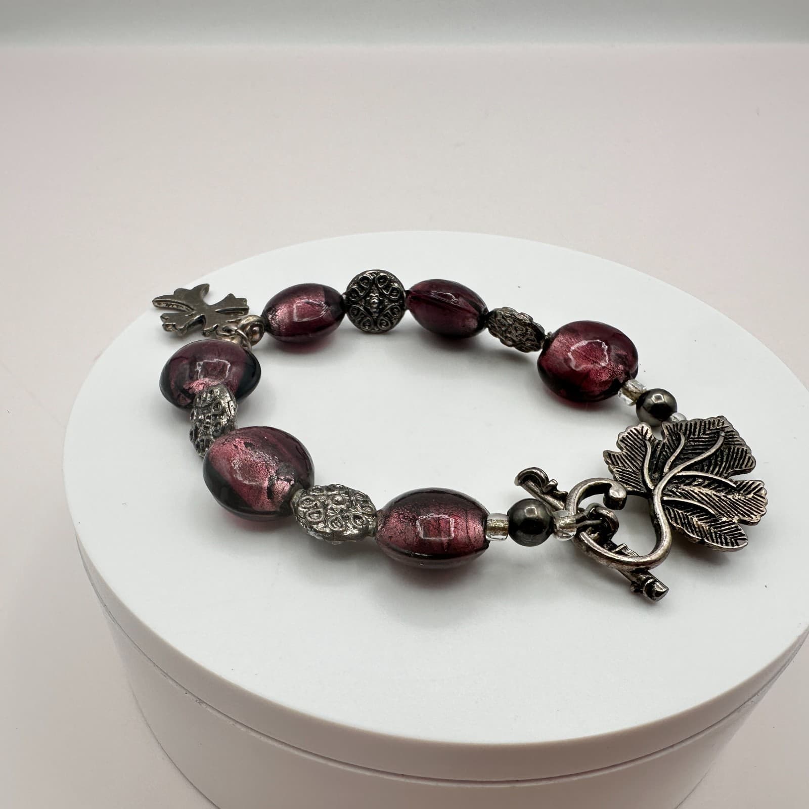 Vintage 90s Silver Tone Leaf Cross Charm Purple Foil Glass Bead Toggle Bracelet