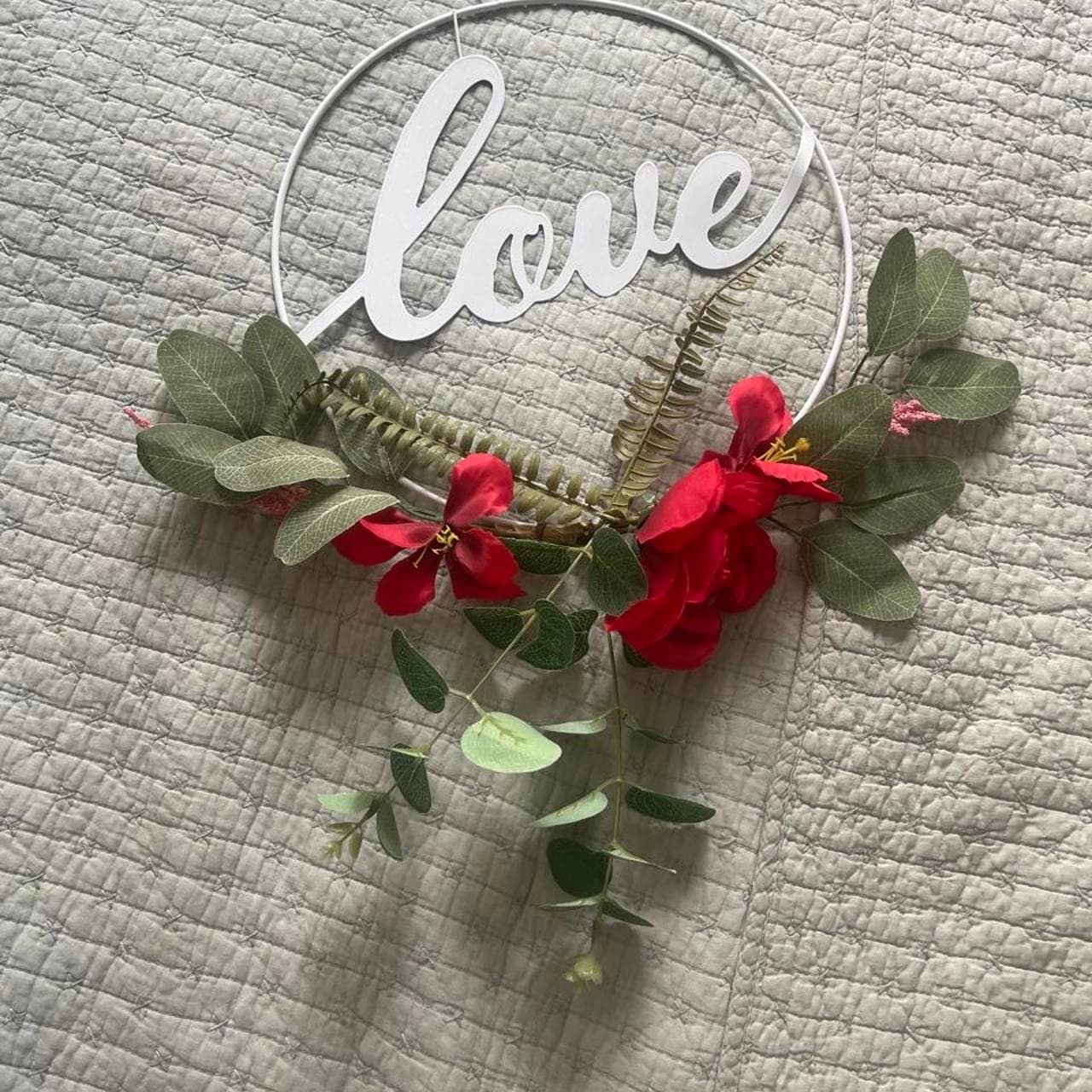 White metal wreath with the word 'love' and red flowers and green leaves #love #valentine
