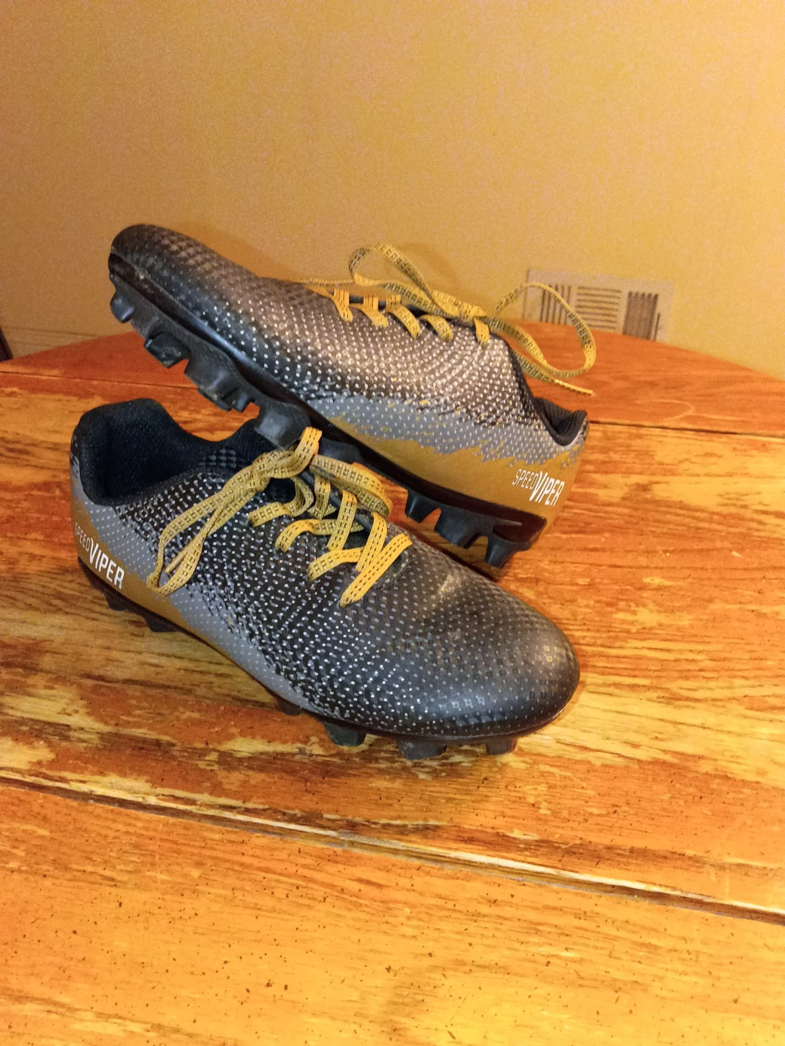 Dick sporting goods kids black and gold cleats size 1.5